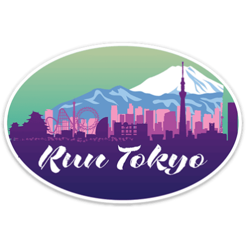 An oval sticker or decal featuring a stylized Tokyo skyline with Mount Fuji, pink and purple buildings, roller coasters, and the text 'Run Tokyo' in white script, shown on a plain white background.